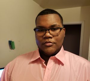 A young man looks at the camera.